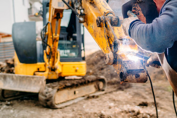 Portrait of mechanical engineer working and welding excavator © aboutmomentsimages