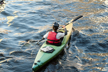  A man in a kayak floating in the River - Powered by Adobe