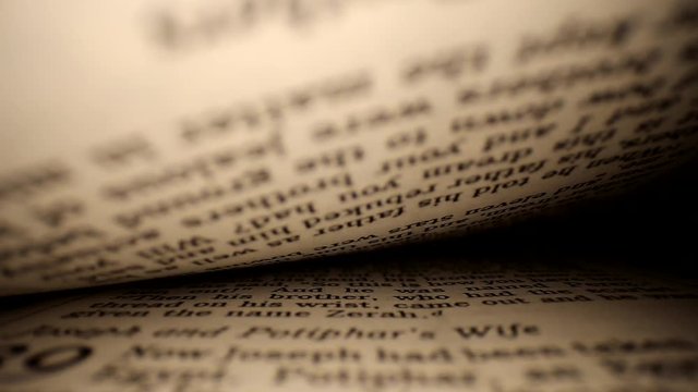 Pushing lens into book center of page. Words eye view of the pages, diagonal slant to start & then arc. Middle focus, stops in middle &then continues.