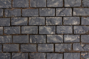 Old cobblestone tile texture in old town. City pavement background. Abstract granite stone brick pattern. Street sidewalk texture