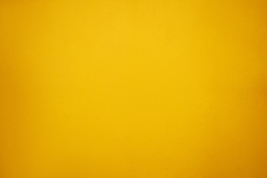 Textured backround. Yellow painted wall.
