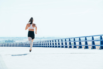 Outdoor shot of a fit young woman running.