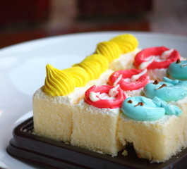 Slice cake piece with cream on top