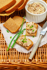 Toast of rye bread with fish pate (rillettes) of smoked. mackerel, cream cheese and green onions . Gourmet appetizer. Picnic. Selective focus