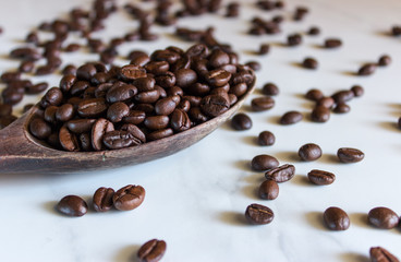 Fresh roasted coffee beans. On the marble floor.