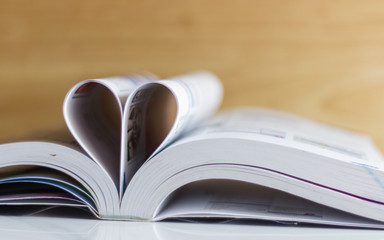 Bible on table with pages folded into heart shape