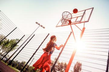 Active teenage girl being team player and throwing ball
