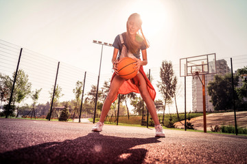Beaming good-looking girl wearing summer outfit while showing