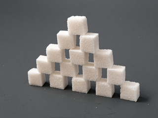 refined sugar lump on gray background yes