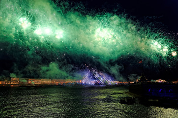 Obraz na płótnie Canvas Fireworks over the water Holiday light. Night cityscape scene. Neva river, Saint-Petersburg, Russia. Holiday Scarlet Sails.