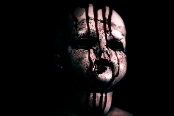 Creepy bloody doll in the dark 