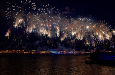 Fireworks over the water Holiday light. Night cityscape scene. Neva river, Saint-Petersburg, Russia. Holiday Scarlet Sails.