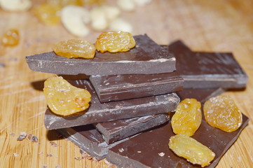 Pieces of chocolate and dried fruits: nuts, raisins