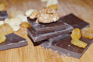 Pieces of chocolate and dried fruits: nuts, raisins