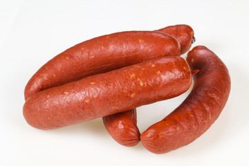 Tasty meat sausages over white background