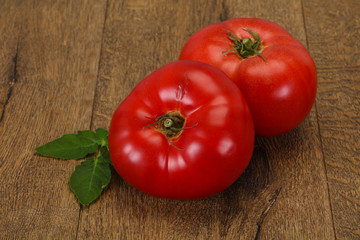 Ripe tomato over wooden background