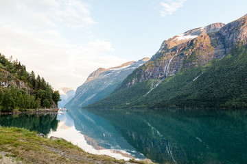 Reflection of mountain landscape on blue idyllic lake