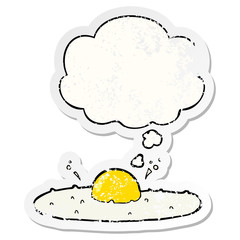 cartoon fried egg and thought bubble as a distressed worn sticker
