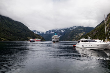 Moored boats and cruise moored on idyllic lake