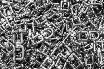 A close up of a box of stainless steel fasteners and clips, ideal for backgrounds
