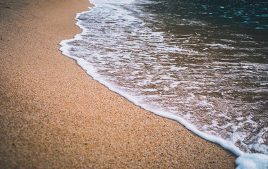 Closeup of sea wave on beach sand
