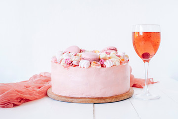 Pink cake. Decoration from sweets, macarons, marshmallows, white chocolate. Sweet birthday present. For girl.
