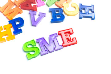 Heap of plastic colored alphabet letters close up. SME