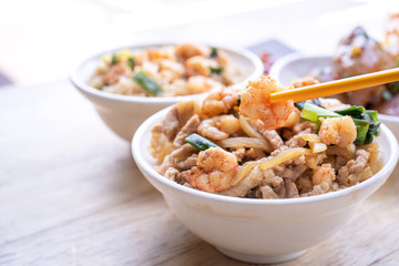 Braised shrimp over rice - Taiwan famous traditional street food. Soy-stewed prawn and sliced pork on cooked rice. Travel concept, copy space, close up