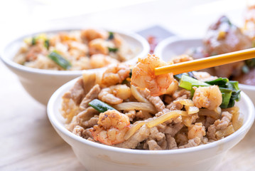 Braised shrimp over rice - Taiwan famous traditional street food. Soy-stewed prawn and sliced pork on cooked rice. Travel concept, copy space, close up