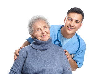Young caregiver with senior woman on white background