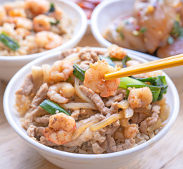 Braised shrimp over rice - Taiwan famous traditional street food. Soy-stewed prawn and sliced pork on cooked rice. Travel concept, copy space, close up