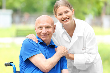 Elderly man with caregiver in park