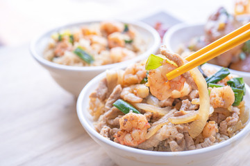 Braised shrimp over rice - Taiwan famous traditional street food. Soy-stewed prawn and sliced pork on cooked rice. Travel concept, copy space, close up