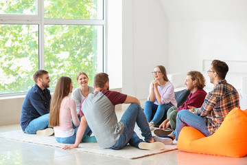 Young people with psychologist at group therapy session