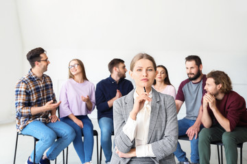 Female psychologist at group therapy session