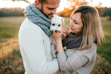 Loving couple with funny pet romantic portrait at nature.