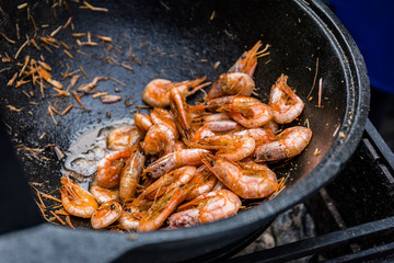 Shrimps fried in a frying pan wok