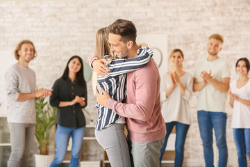 People hugging at group therapy session