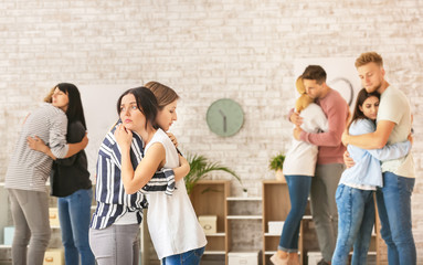 People hugging at group therapy session