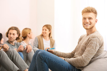 People with psychologist at group therapy session