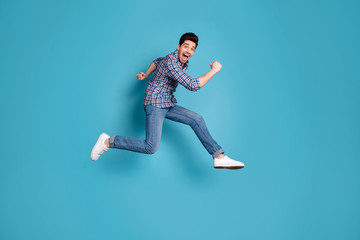 Full length body size view photo handsome cute youth shout content candid rejoice free time holidays weekend spring wear checked modern shirt denim sneakers isolated blue background