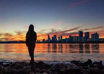 Woman contemplating life at sunset
