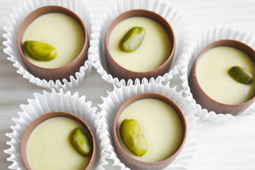 Round chocolates with pistachio filling