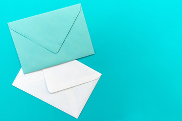 Blue and white envelopes are isolated on a light blue background. Concept greeting card.Copy space.