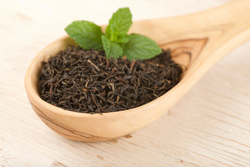 black tea on wooden background