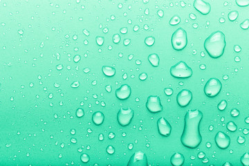 Drops of water on a color background. Green. Toned
