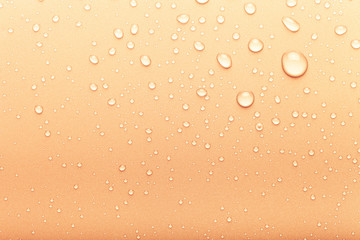 Drops of water on a color background. Orange. Toned