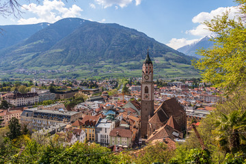 Skyline panorama of main District of City Meran with Church, Vegetation and Mountains. Merano. Province Bolzano, South Tyrol, Italy. Europe.