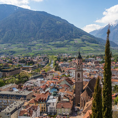 Obraz premium Panoramic view on skyline of central District of City Meran with Church, Vegetation and Mountains. Merano. Province Bolzano, South Tyrol, Italy