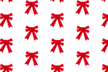 Red bows on white background. Trendy festive pattern.